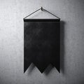 Black blank pennant hanging on concrete wall. Ready for your business information. High detailed texture material. Abstract backg Royalty Free Stock Photo