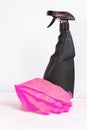 Black blank plastic spray detergent bottle and pink rubber gloves  on white background. Household chemicals. Cleaning product Royalty Free Stock Photo