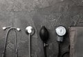 Black blood pressure monitor on a black marble background.