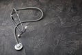 Black blood pressure monitor on a black marble background.