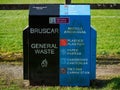 Black and blue general waste bin in a park