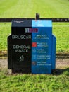 Black and blue general waste bin in a park