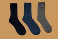 Black, blue, gray socks on brown background. Royalty Free Stock Photo