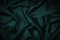 Black blue green abstract background. Dark green silk satin texture background. Beautiful wavy soft folds on the surface of the fa Royalty Free Stock Photo