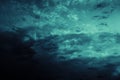 Black blue green night sky with clouds. Storm. Dramatic dark skies background. Glow, light. Mystical, fantasy. Or ominous, spooky.