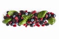 Black-blue and red berries isolated on white. Ripe blackberries, blueberries, raspberries, cornels and basil leaves on white backg Royalty Free Stock Photo