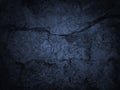 Black blue rough background. Toned rock texture with cracks. Macro. Dark blue grunge background. Old stone wall. Royalty Free Stock Photo