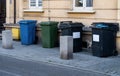 Black, blue, yellow, green garbage containers in city. Separate waste, preserve the environment concept. Segregate waste,