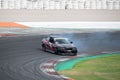 Black BMW E36 driving fast on a competition track