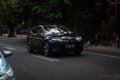 black BMW iX xDrive40 electric car driving fast on the road blurry in motion