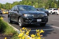 A black BMW X4, a compact luxury crossover SUV parked in a parking lot Royalty Free Stock Photo