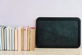 Black board and many old books. Copy space, back to school Royalty Free Stock Photo