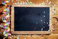 Black Board on Table with Streamers and Confetti