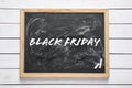 Black board with text BLACK FRIDAY and pieces of chalk on white table, top view Royalty Free Stock Photo