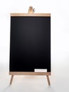 Black board with of two pieces of chalks on wooden easel isolated on white background