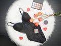 Black body, orange roses, lipstick, perfume and eye shadow. Fashionable concept Royalty Free Stock Photo