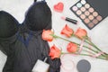 Black body, orange roses, lipstick, perfume and eye shadow. Fashionable concept Royalty Free Stock Photo