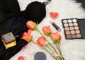 Black body, orange roses, lipstick, perfume and eye shadow. Fashionable concept Royalty Free Stock Photo