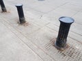 Black bollard and street or road with grey cement