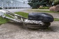 black bollard with ropes. Close-up. On the back blurry background, a ship is visible Royalty Free Stock Photo