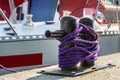 Black bollard with a synthetic rope in a harbor Royalty Free Stock Photo