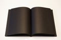 Black book lying open on white background Royalty Free Stock Photo