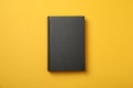 Black book on yellow background Royalty Free Stock Photo