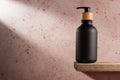 Black bottle with dispenser pump for cosmetics and beauty or bathroom products Royalty Free Stock Photo