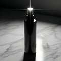 Black Bottle with Sprayer on Marble Surface Royalty Free Stock Photo