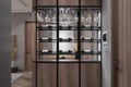 Black Bottles and Glass Rack For Home Bar Interior In Dining Space