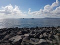 Black boulders on the blue sea