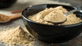 Black Bowl of Beige Ginger or Maca Powder with Spoon Royalty Free Stock Photo