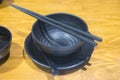 A black bowl chopsticks and spoon Royalty Free Stock Photo