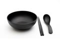 black bowl chopsticks and spoon on white Royalty Free Stock Photo