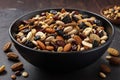 Black bowl full of trail mix over wooden table Royalty Free Stock Photo