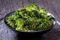 Black bowl with kale chips on the table Royalty Free Stock Photo