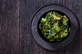 Black bowl with kale chips on the table Royalty Free Stock Photo