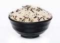 Black bowl of raw organic basmati long grain and wild rice on white background. Healthy food Royalty Free Stock Photo