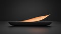 A black bowl with a single orange leaf on top sits on a black surface. Royalty Free Stock Photo