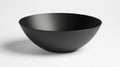 A black bowl with a smooth surface and a slightly curved shape. Royalty Free Stock Photo