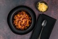 Black bowl of spicy chili con carne on a rustic moody background Royalty Free Stock Photo