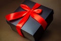 Black box with a red ribbon and bow on a gold background. Abstract: gift, intrigue, surprise Royalty Free Stock Photo