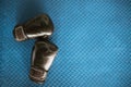 black boxing gloves on blue iron flooring Royalty Free Stock Photo