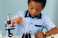 Black boy mixing chemicals in lab Royalty Free Stock Photo