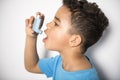 A black Boy using an asthma inhaler Royalty Free Stock Photo