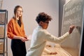 Black Boy Writing On Blackboard At Music Lesson