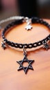 A black bracelet with a star of david charm and silver stars, AI Royalty Free Stock Photo