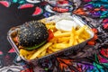 Black bread burger with French fries Royalty Free Stock Photo