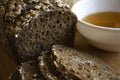 Black bread near a cup with honey