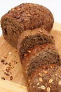 Black bread on table with few slice